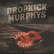 El texto musical WATCHIN THE WORLD GO BY de DROPKICK MURPHYS también está presente en el álbum Okemah rising (2023)